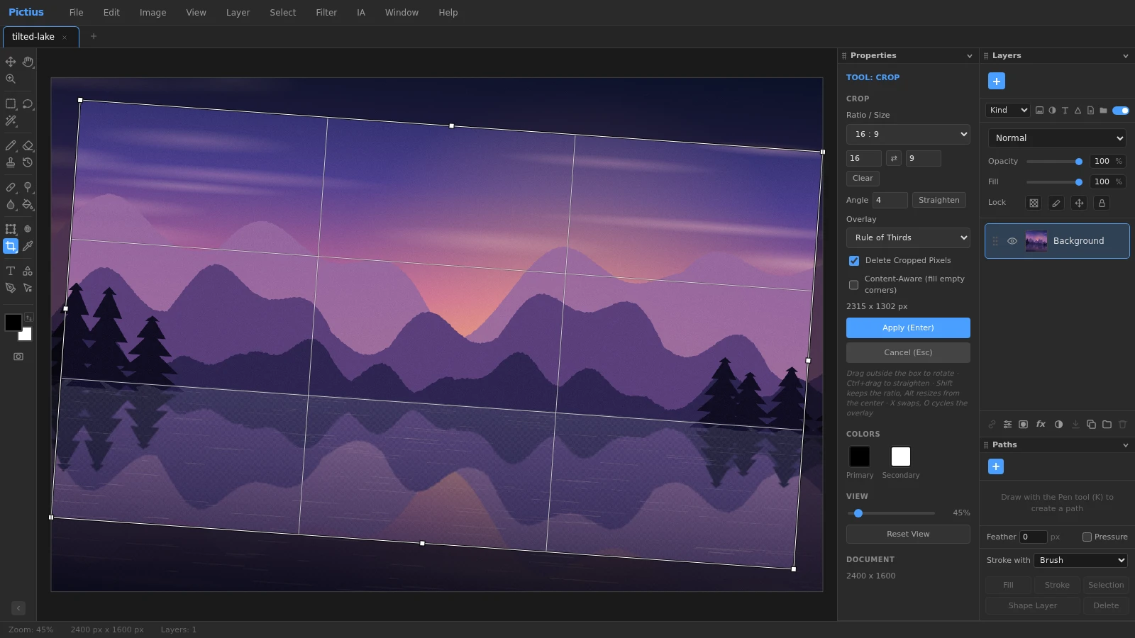 The Crop tool in Pictius on a lake photo, with a 16:9 crop box rotated to level the horizon, the rule of thirds overlay and the crop options in the Properties panel